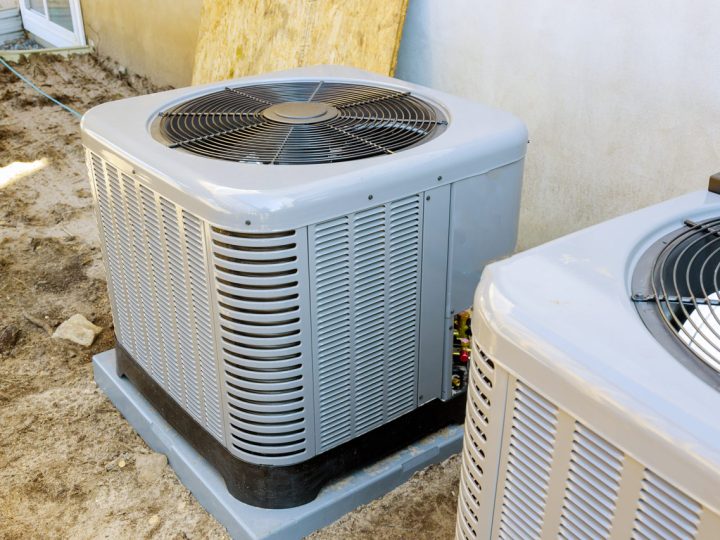 two units of heat pump air conditioner installed outside a house