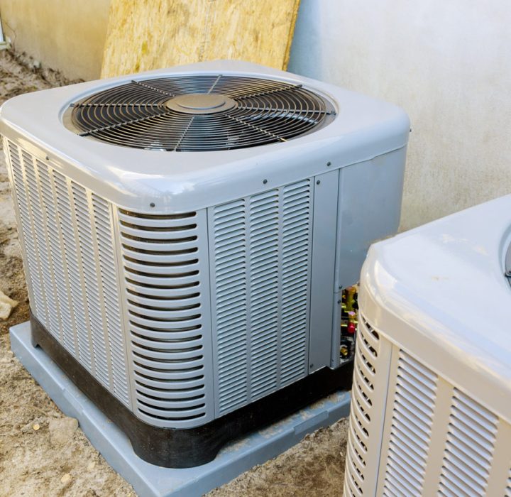 two units of heat pump air conditioner installed outside a house