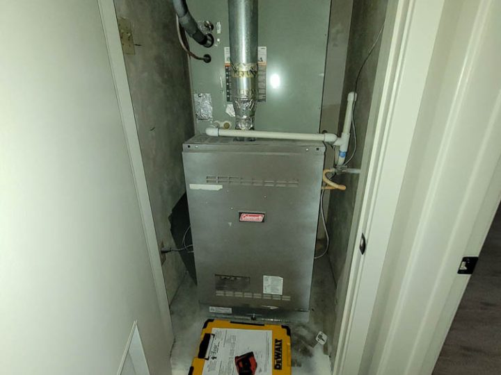 A dependable boiler installed in a compact utility room with a network of pipes and valves connected to it
